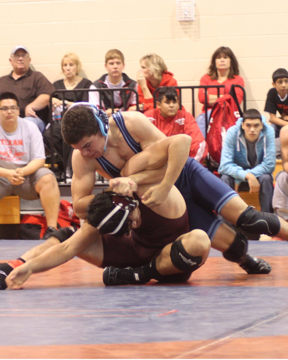 Junior Chris Mitchell muscles down his opponent