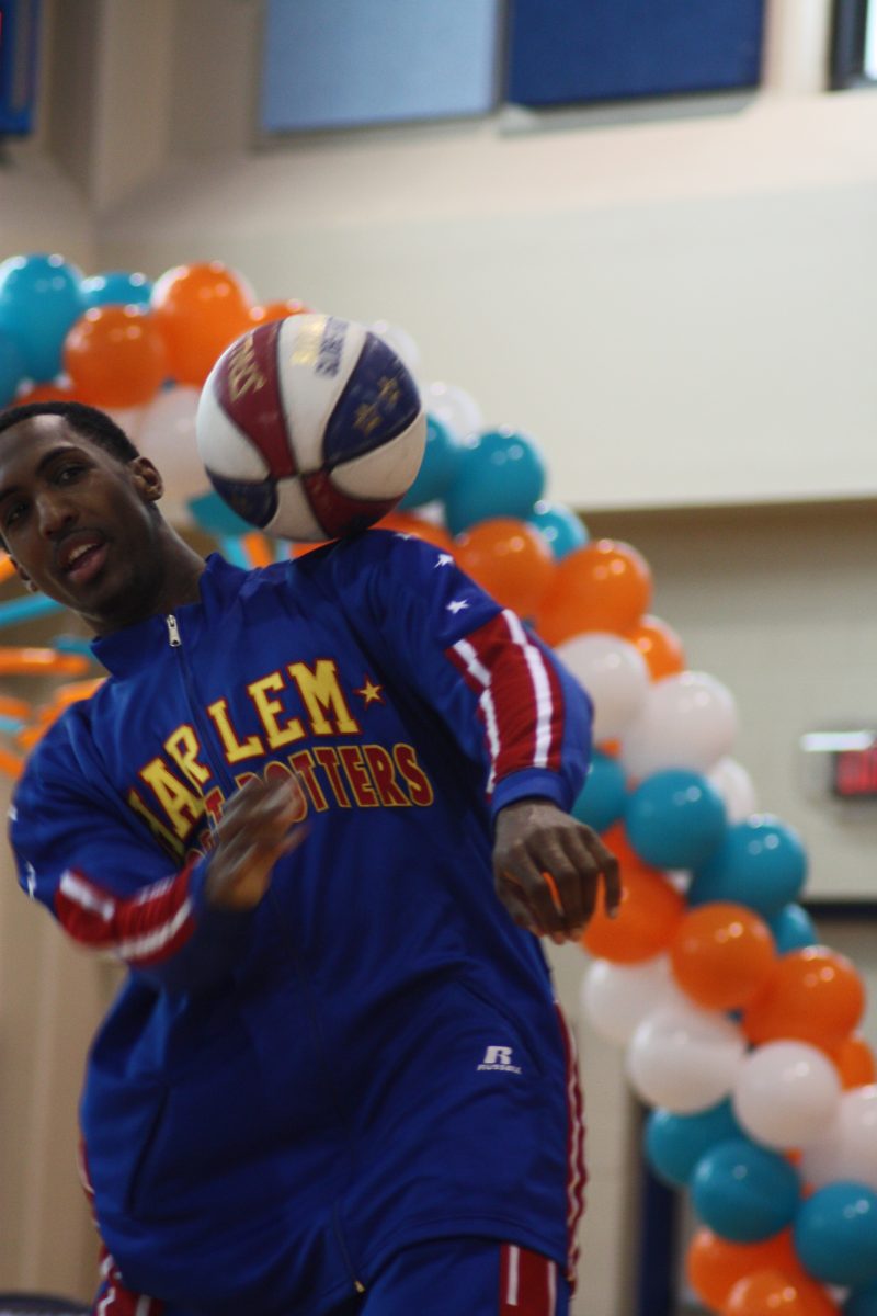 Globetrotter+shows+off+his+acquired+skill+by+balancing+ball+on+his+shoulder.