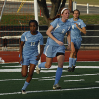 Sophomore Nia Stallings and freshman Amber Stearns run up the field during an intense game.