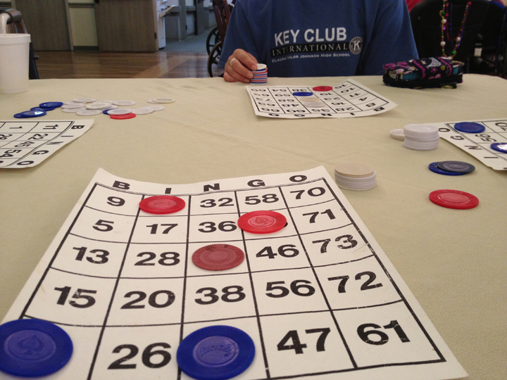Students spend time with the elderly, playing bingo and making memories.