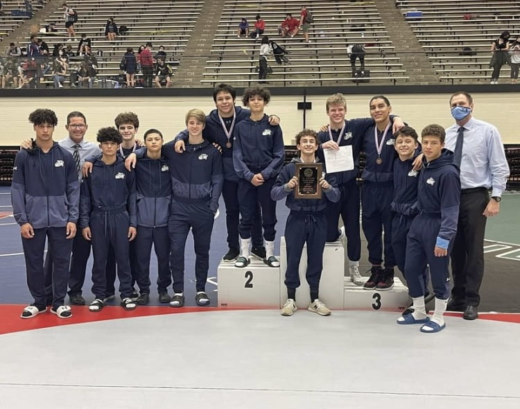 Wrestlers standing for a group picture after regionals at the Blossom Athletic Center (Picture by Julian Guerra)