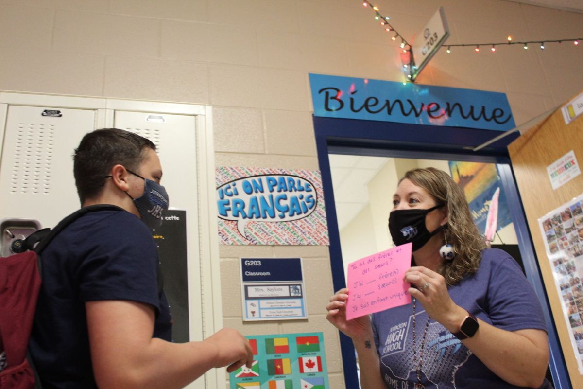 French teacher provides practice for students at door
