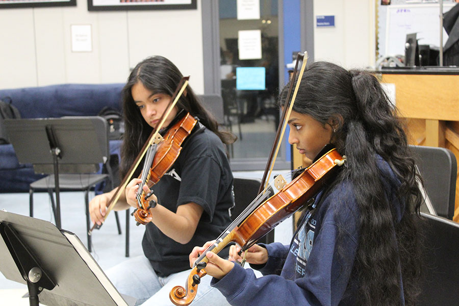 MUSIC TO YOUR EARS
Freshmen Angelica Trevino (left) and Alaina Cyril (right) are rehearsing their program for the upcoming orchestra Final Concert on May 7, 2024. They will be performing a piece from the movie “How to Train Your Dragon” as well as other familiar sounds such as “Merry Go Round of Life” and “Blinding Lights”. “You should definitely come watch us play,” Cyril said. 