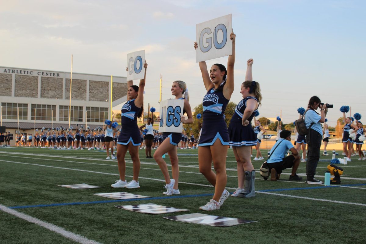 Daniela Diamond teaches the crowd at Meet the Jags the cheer Go Jags Go holding the a sign. Diamond was feeling nervous about teaching the crowd the cheer. "Cheer means like a hole in my life that's been filled," Diamond said.
