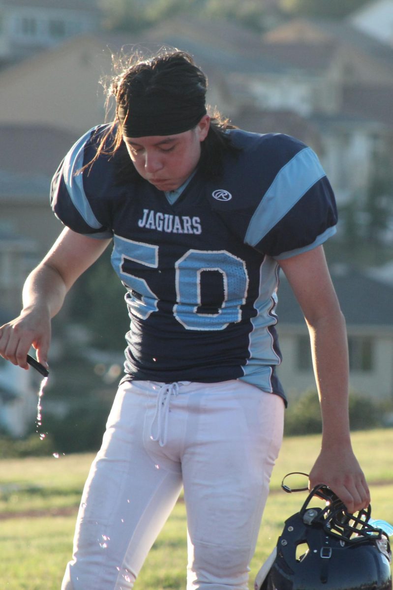 TAKE ON WATER
After playing in 100 degree weather, Christian Aguillon drinks lots of water. During football season, when the players would get hot they would pour the water into their helmets because it felt good. “ It is a place outside of school where you get to try your hardest,” Aguillon said. Photo by Mariyah McRae
