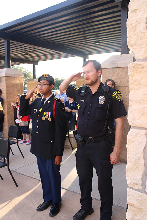 Honor and Pride
Benjamin Nakprommin salutes the campus police officer during the morning of 9/11. Every year they have a morning ceremony in front of the school in honor of 9/11. "We show honor and tribute to those fallen during the 9/11 attacks," Nakprommin said.. Photo by Jackson Coleman